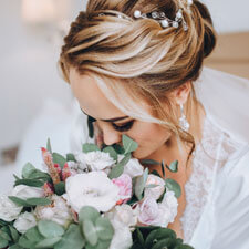 Bride Smelling Flowers